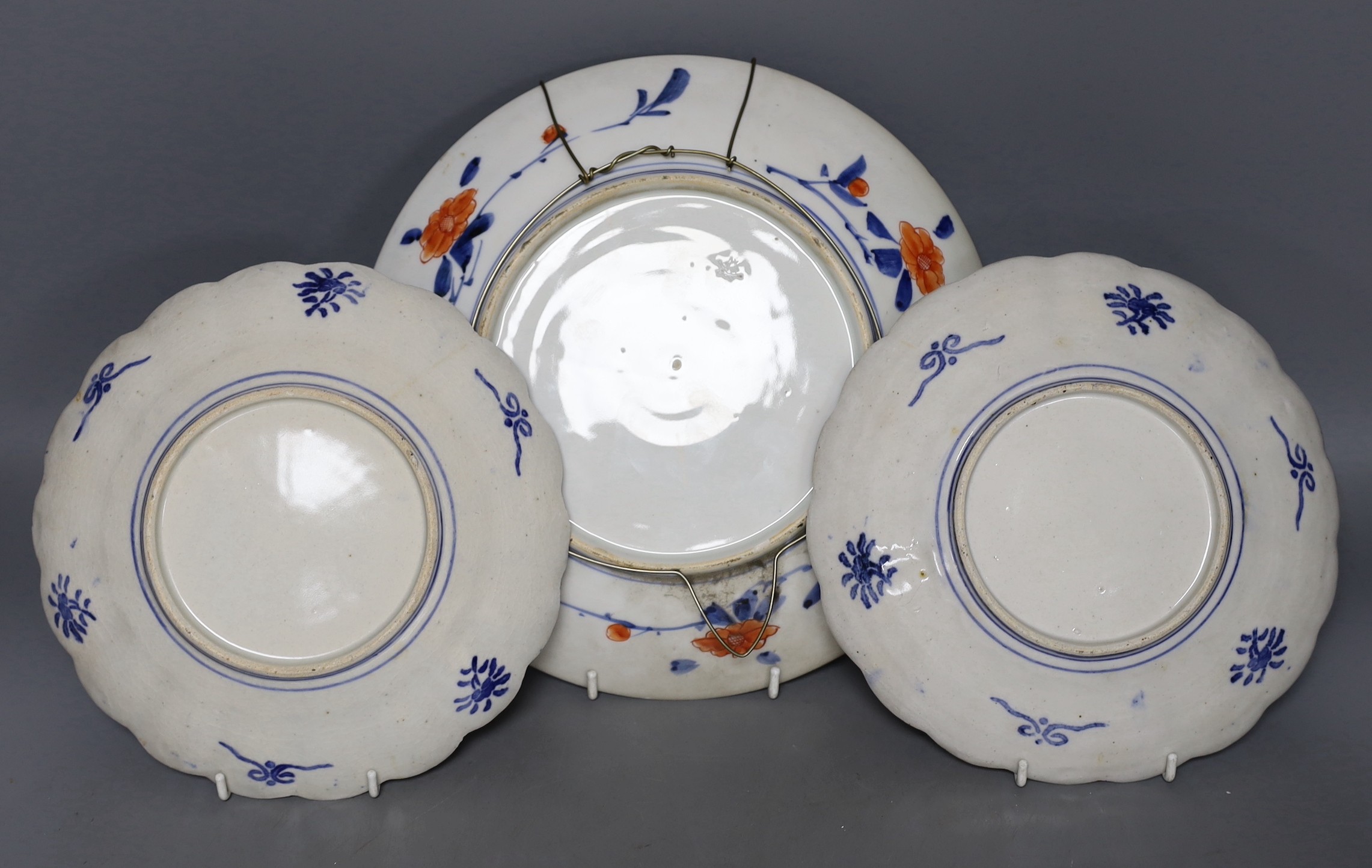 A pair of Japanese Imari plates and similar dish, 27cm